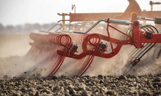 Agricultural cultivator preparing soil in farming field