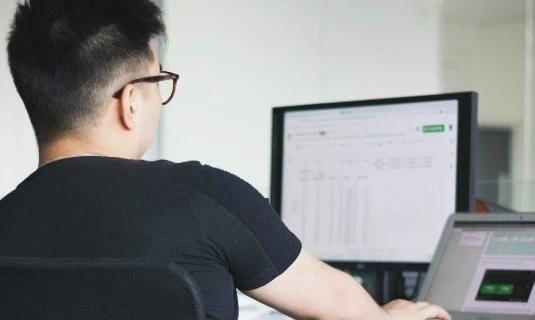 Business analytics dashboard on desktop monitor for aftermarket performance tracking