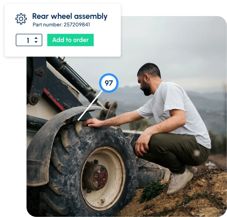 Technician inspecting rear wheel assembly of heavy machinery with part reference overlay