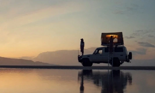 Utility vehicle with rooftop tent representing mobility and field service