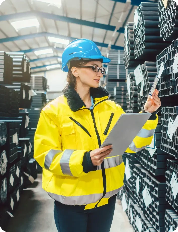 Warehouse worker scanning industrial parts inventory using tablet in product information system