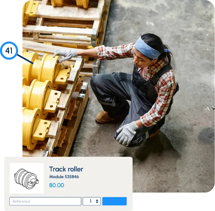 Worker inspecting heavy equipment track rollers with part number and pricing overlay